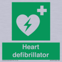 green-background-with-white-text-and-heart-defibrillator-symbol--white-cross-and~